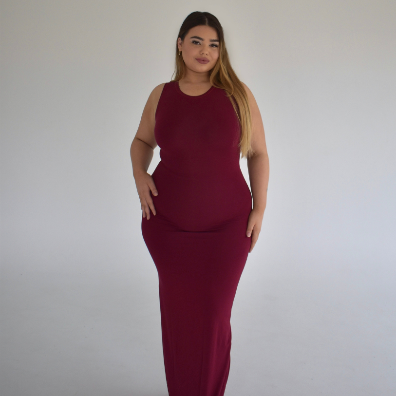 A model wearing a red, maxi, sleeveless, V-neck dress.